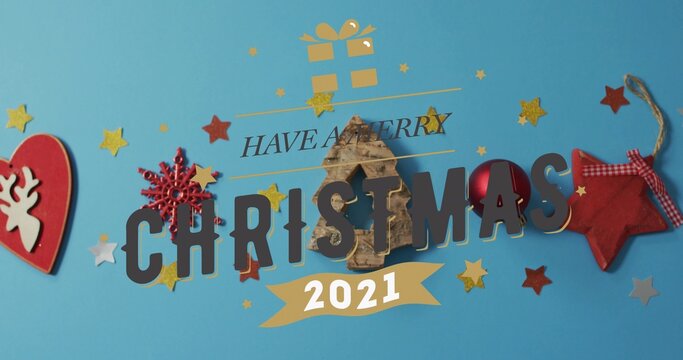 Featuring CHRISTMAS lettering and wooden tree ornament on teal tabletop, with ribbon 2021