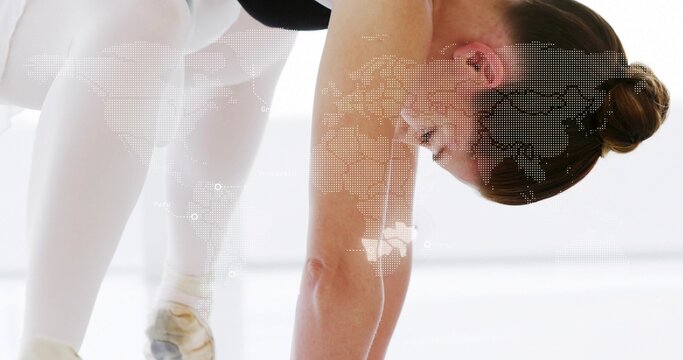 Bending dancer folding in studio black leotard white tights pointe shoes bun worldmap overlay