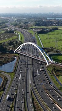 Aerial view of the Zandhazenbrug near Muiderberg in the Netherlands, showing the long-span railway bridge crossing the A1 motorway and major rail and road infrastructure.