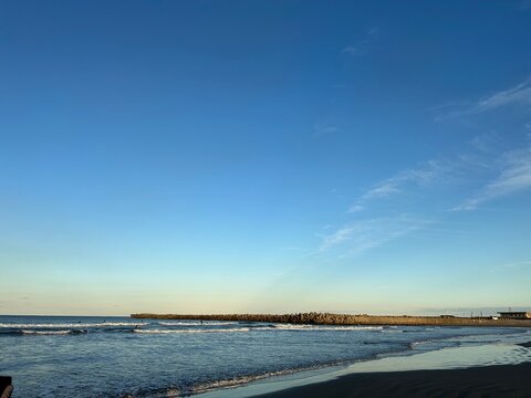 Quiet sandy beach at dusk under a clear gradient sky