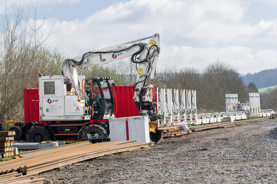 Onville, France - March 15th 2026 : View on a white road-rail wheeled excavator D2R ZX170-7 PRR on a construction site for the renovation of a railway line.