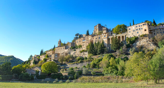 Landscape with hilltop village Montbrun-les -bains in the French Provence under blue sky