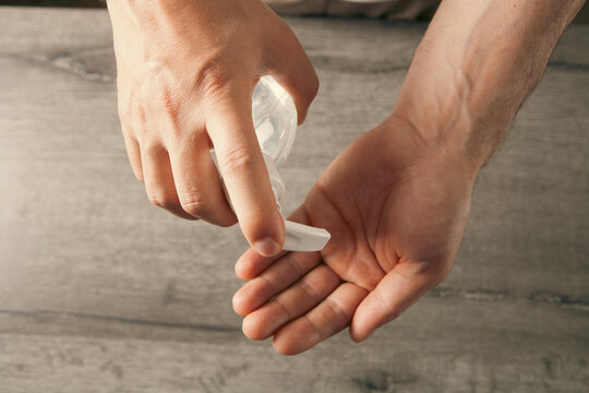 Hand sanitizer gel dispenser in the hands of a man