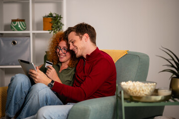 Happy couple shopping online with credit card on tablet © Zoran Jesic
