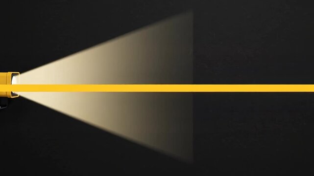 Yellow spotlight lamp mounted on dark black wall surface providing bright directional illumination for interior