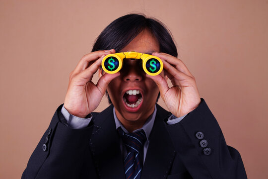 Excited Businessman Spotting Financial Opportunity Through Binoculars Against Brown Background