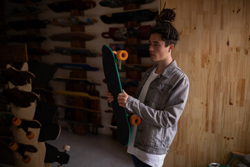 Young male skateboarder choosing skateboard in shop © WavebreakMediaMicro