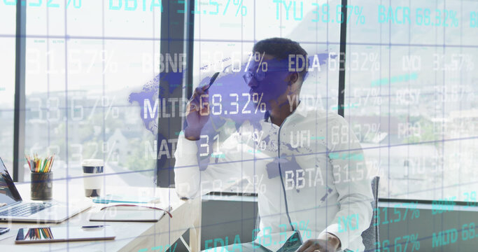 Stock market data processing against stressed african american businessman at office