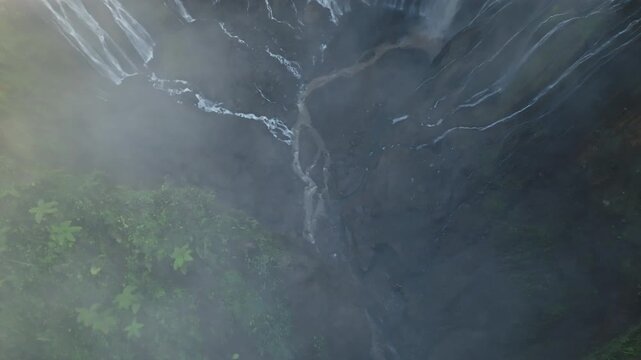 Aerial view of Panorama Tumpak Sewu Waterfalls also known as Coban Sewu.Beautiful rainbow and fog,Tumpak Sewu Waterfalls are a tourist attraction in East Java, Indonesia.Amazing travel destination