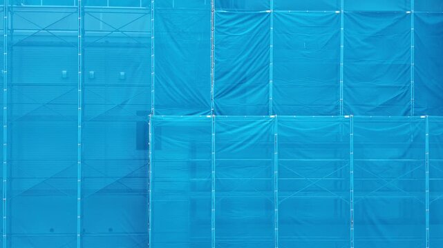 Construction Site with Blue Safety Mesh Scaffolding in Matsumoto