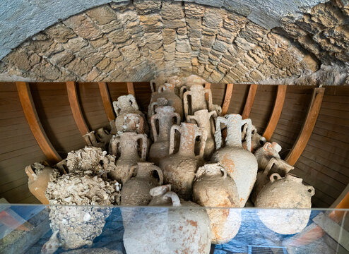 Ancient amphorae cargo inside wooden shipwreck model in Marmaris Castle, Turkey
