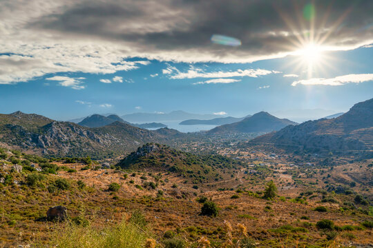 Panoramic view of Sogut village hills overlooking Symi island and Aegean sea under sunny sky, Marmaris, Turkey