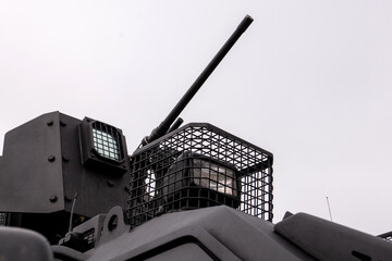 Low angle view of automated security turret mechanism with optical sensor lens and protective metal mesh grid grill on vehicle roof © MarijaBazarova