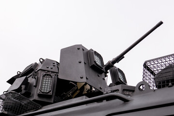 Low angle view of automated security turret mechanism with optical sensor lens and protective metal mesh grid grill on vehicle roof © MarijaBazarova