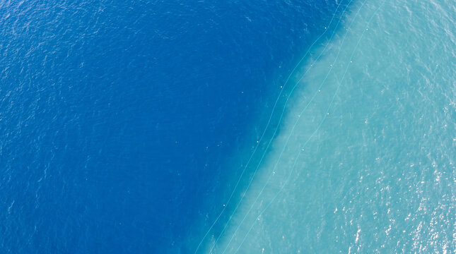 Aerial View of Deep Blue and Turquoise Ocean Water Boundary with Subtle Digital Contour Lines