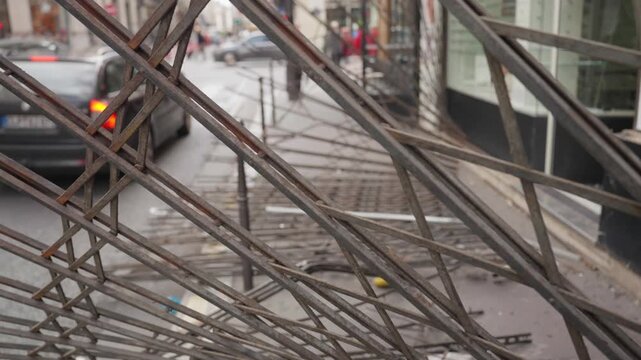Protective metal security grate on shop window facing paris street during unrest