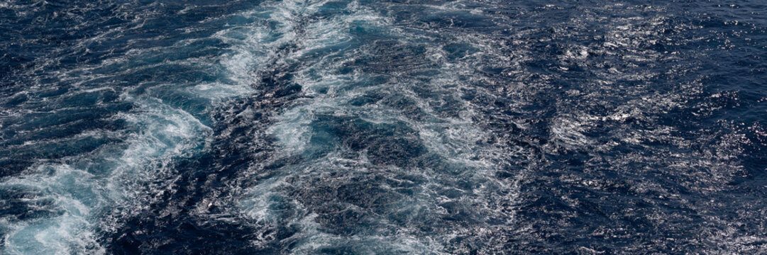 Waves and turbulence from the wake of a boat in the sea as a background texture