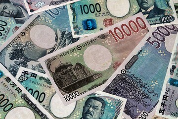 Japanese yen money bills in pile. Big amount of Japan JPY currency cash close up © Viktor