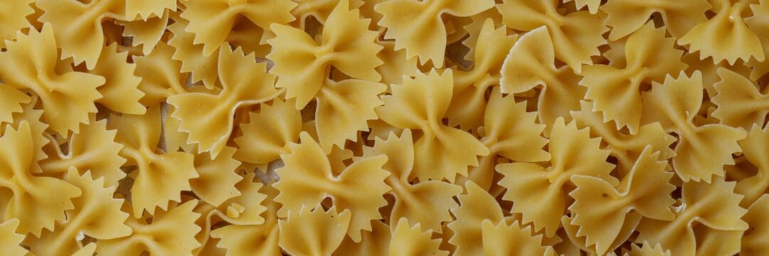 Uncooked Farfalle Pasta, Bow-Tie Macaroni Creating a Lively and Textured Background