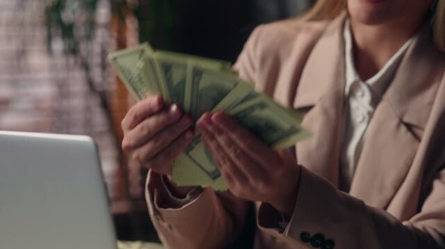 Close up female hands holding money cash celebrating excited business woman with finance in office happy wealthy Caucasian businesswoman specialist with banknotes joyful reaction financial profit