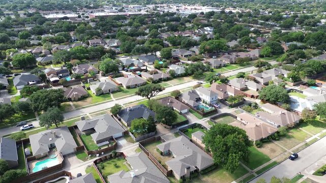 Orderly pitched roofs dominate dense residential quarters in Dallas County subdivisions along Richardson. Private yards feature flourishing lawns, concrete patios, Texas, Richardson, Texas