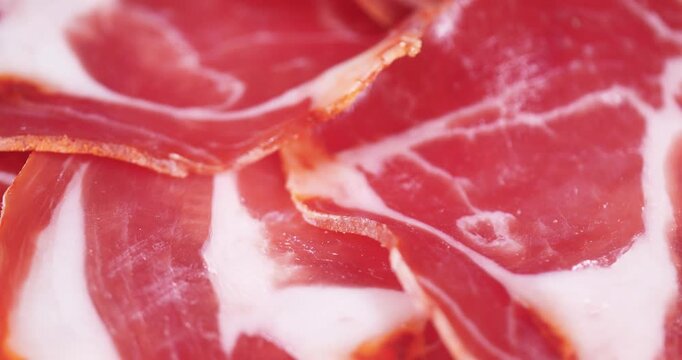 Side View Texture Background Of Sliced Pork Brisket Resembling Gourmet Prosciutto Meat Rotating Background. Detailed Close Up Of Marble Raw Ham Layers With Distinct Fat Streaks