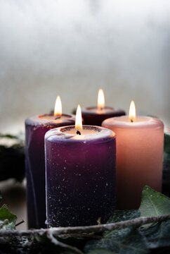 Close up of traditional Advent Christmas wreath with purple and pink candles.