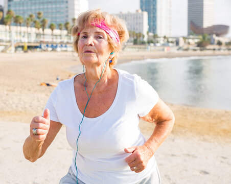 Old lady running beside beach