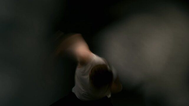 Young adult Caucasian man performing expressive contemporary dance movements. Footage serves performing arts campaigns, music videos, creative theatre promotions