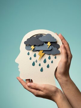 Paper cut human head silhouette with stormy clouds rain and lightning for mental health awareness