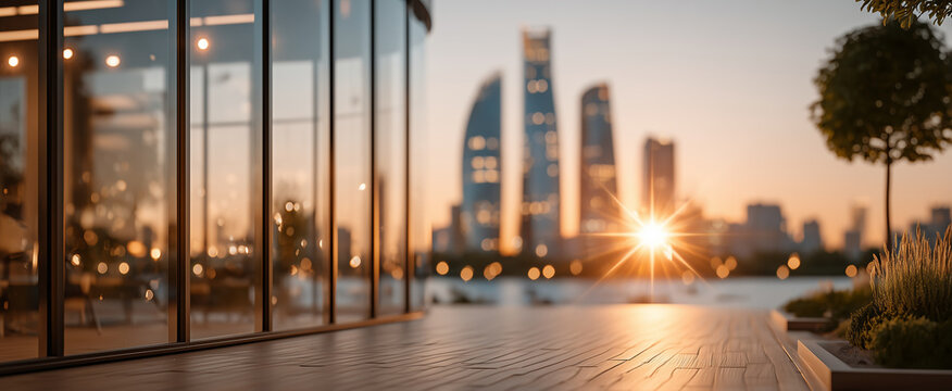 Glass office frontage facing city towers at golden sunset