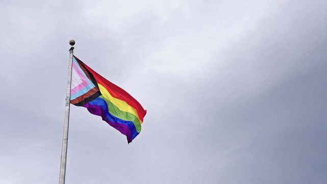 LGBT community. Tolerance and equality. World gay pride. Rainbow gay flag. Pride month. LGBTQ rainbow flag. LGBT rainbow flag waving against sky. Symbol of pride and LGBTQ. Colorful pride flag