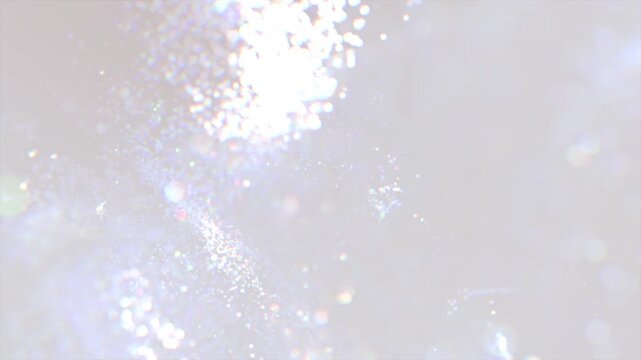 White glitter background. Soft abstract bokeh with rainbow highlights, creating an atmosphere of dreaminess and lightness. Can be used as overlay elements for design projects. 