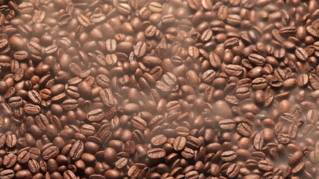 Freshly roasted coffee beans in motion, closeup macro, shrouded in rising smoke and steam.