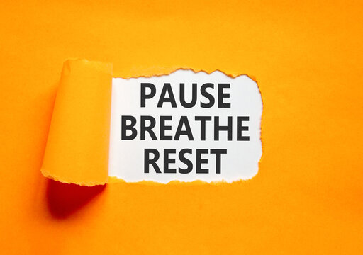 Pause breathe reset words symbol. Concept words Pause breathe reset on beautiful white paper. Beautiful orange background. Business support motivational and pause breathe reset concept. Copy space.
