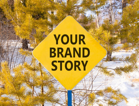 Branding and your brand story symbol. Concept words Your brand story on beautiful yellow road sign. Beautiful winter forest background. Business branding your brand story concept. Copy space.