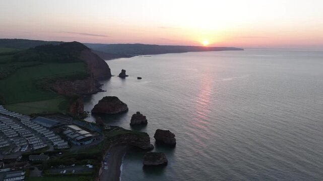 Sunrise aerial over the cliffs and sea stacks of Ladram Bay, Devon, England