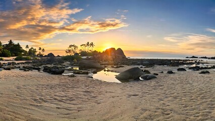 Sunset at tropical beach with granite boulders and reflection on sand © Dy