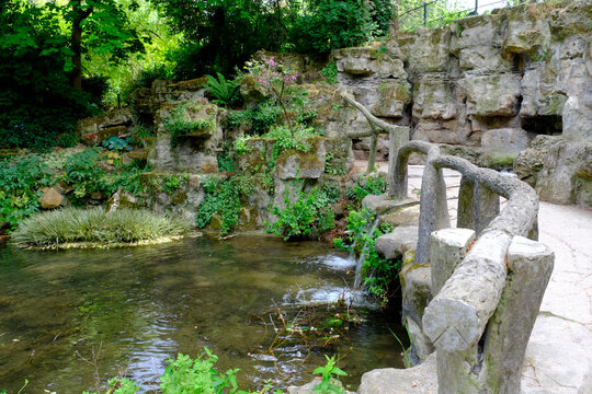 Stream and stone steps in lush green garden