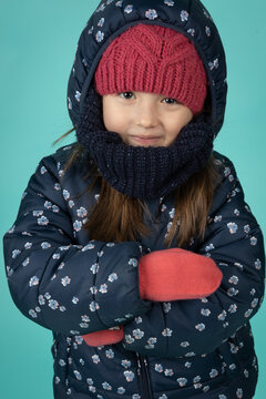 Cute Little Girl Bundled in Warm Winter Puffer Jacket Knitted Hat and Mittens
