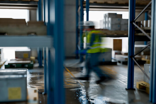 3D warehouse interior with motion blur worker pushing cart between storage racks
