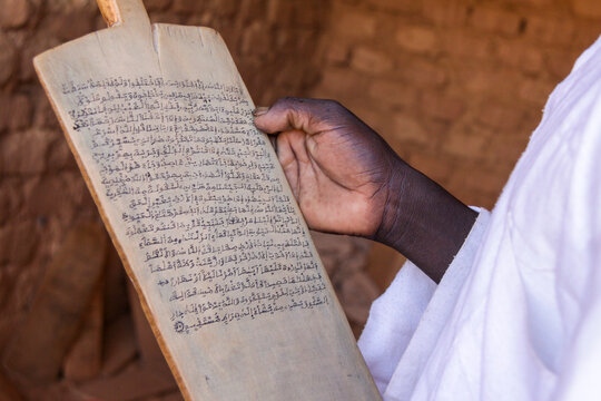 Hand holding a wooden tablet with Arabic script in a Koranic school, Sahel Region, Bani, Burkina Faso