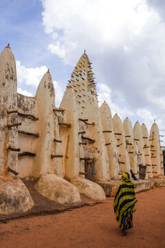 Woman in yellow and black veil walking toward the Grand Mosque, Hauts-Bassins Region, Bobo Dioulasso, Burkina Faso