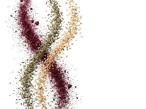 Floating Sumac Powder, Dried Thyme, and Toasted Sesame Seeds on White Background