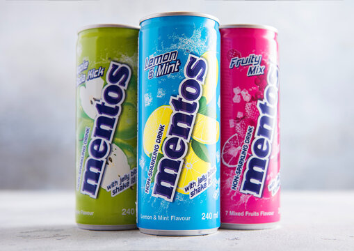 LONDON,UK - MAY 05, 2026: Cans of Various Mentos Fruity Mix non sparkling soda drink with jelly bites on light table background.