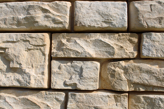 Mur de sout&egrave;nement ou de cl&ocirc;ture en blocs modulaires de b&eacute;ton pr&eacute;fabriqu&eacute;, teint&eacute;s dans la masse, imitant la pierre de taille