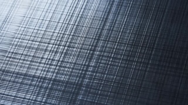 Brushed metal surface with fine scratched lines and crosshatch texture in closeup view
