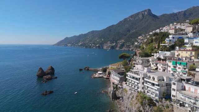 Aerial flight past Due Fratelli sea stacks to Marina di Vietri - Italy