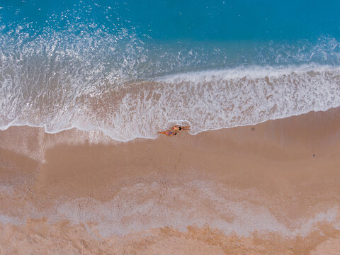 Young woman posing at Ocean Shoreline for a drone shot
