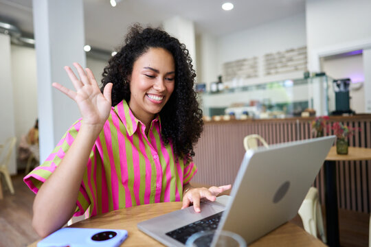 Individual having video call remote work from cafe